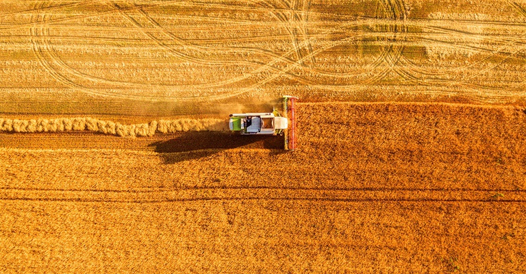 Harvester machine working in field, LALS Stock | Shutterstock